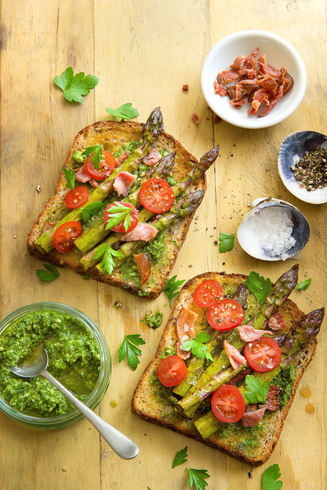 Toastie sandwiches, asparagus spears, crispy bacon and cherry tomatoes with mixed herbs