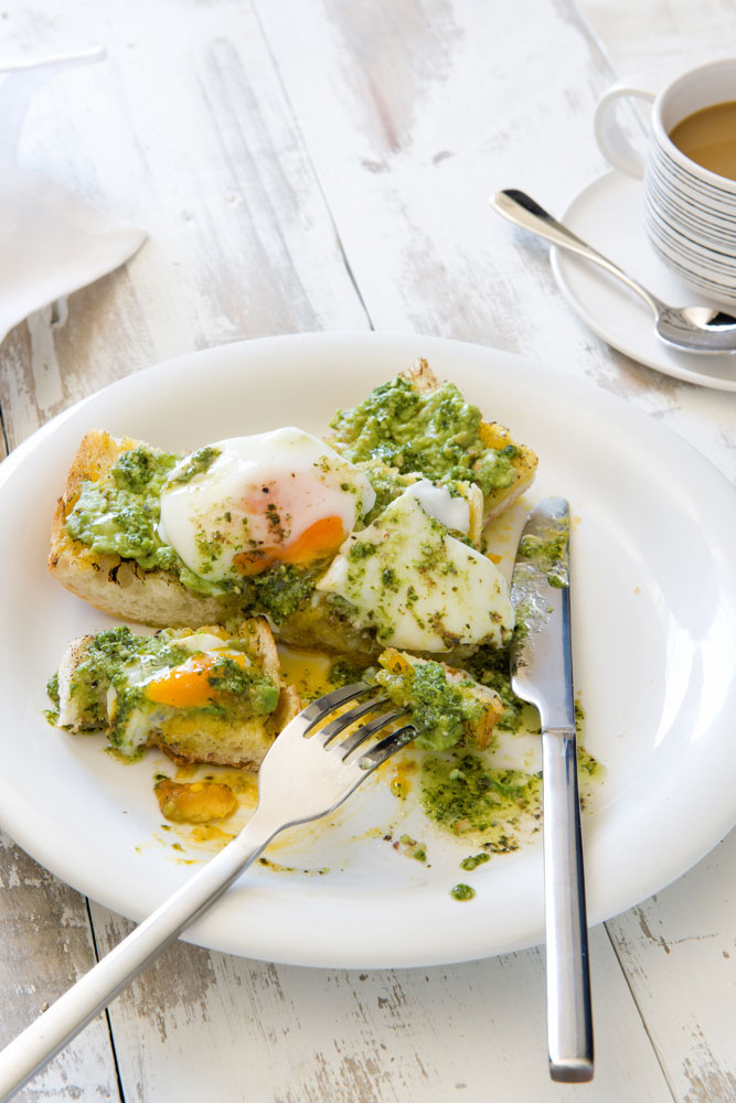 Friday breakfast, poached eggs, avacardo with fresh Genoese pesto on sour dough with coffee