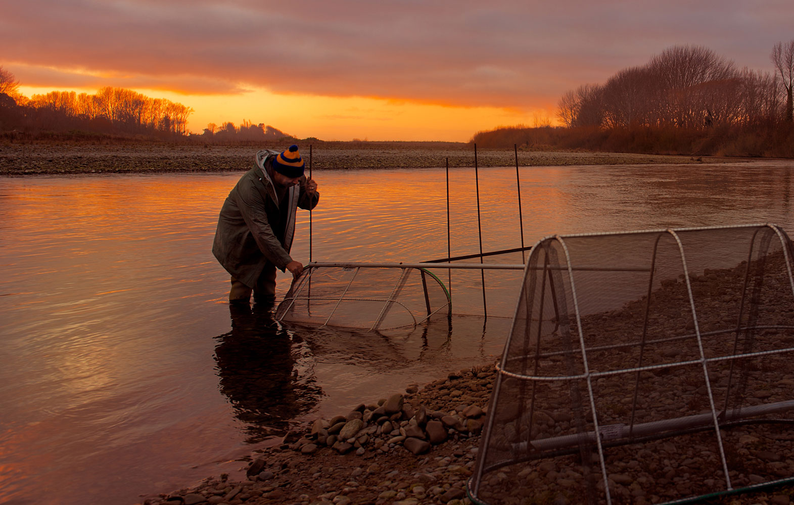 John, whitebaiting in a river